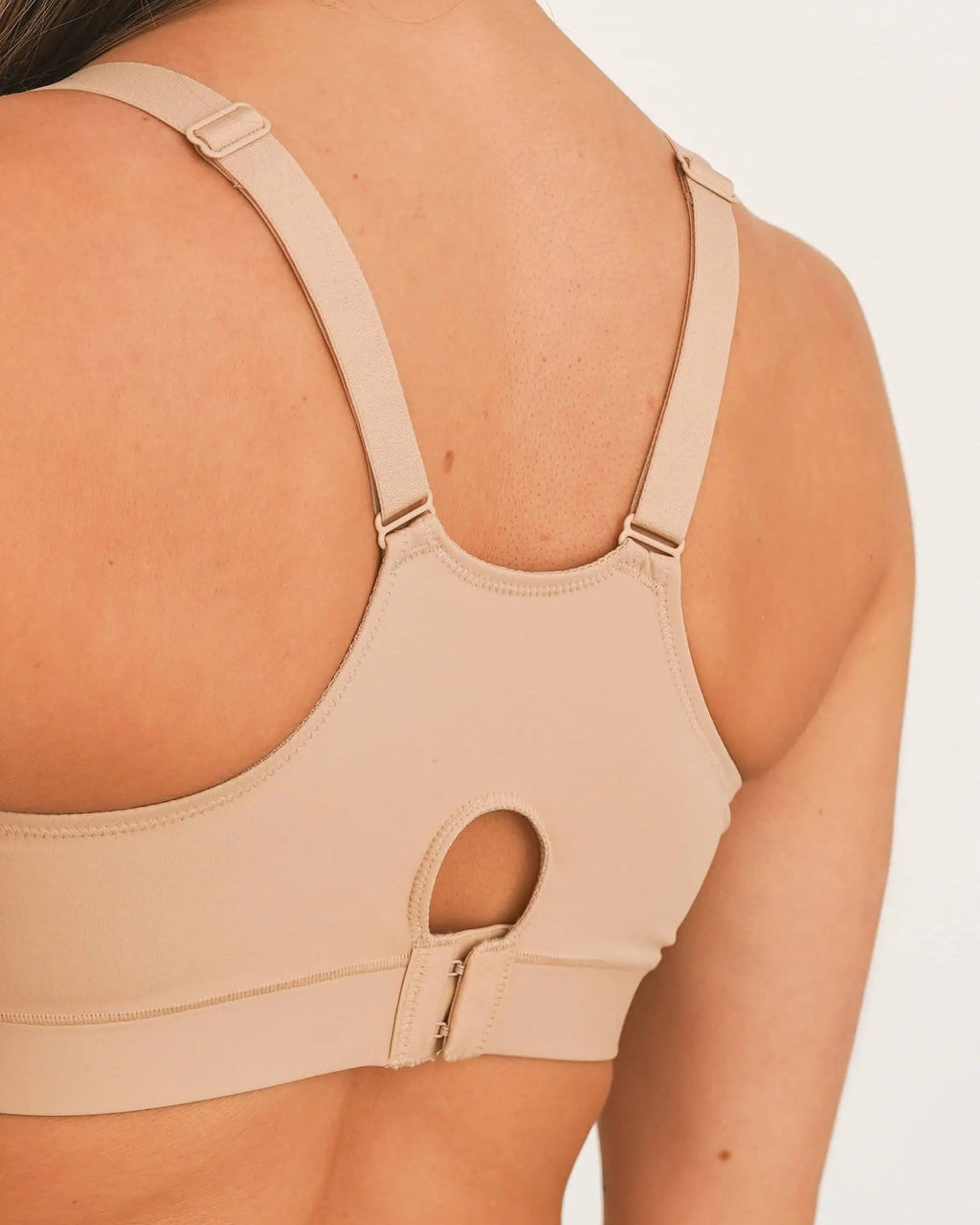 Back view of nude non lace post surgical compression bra with adjustable straps and keyhole back opening